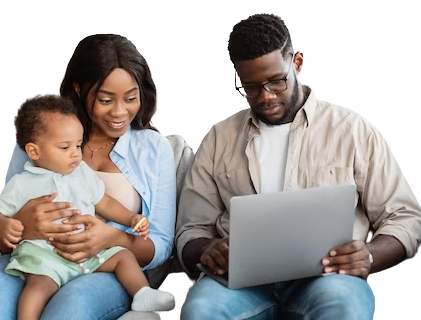 A family sitting together on a couch, browsing on a laptop